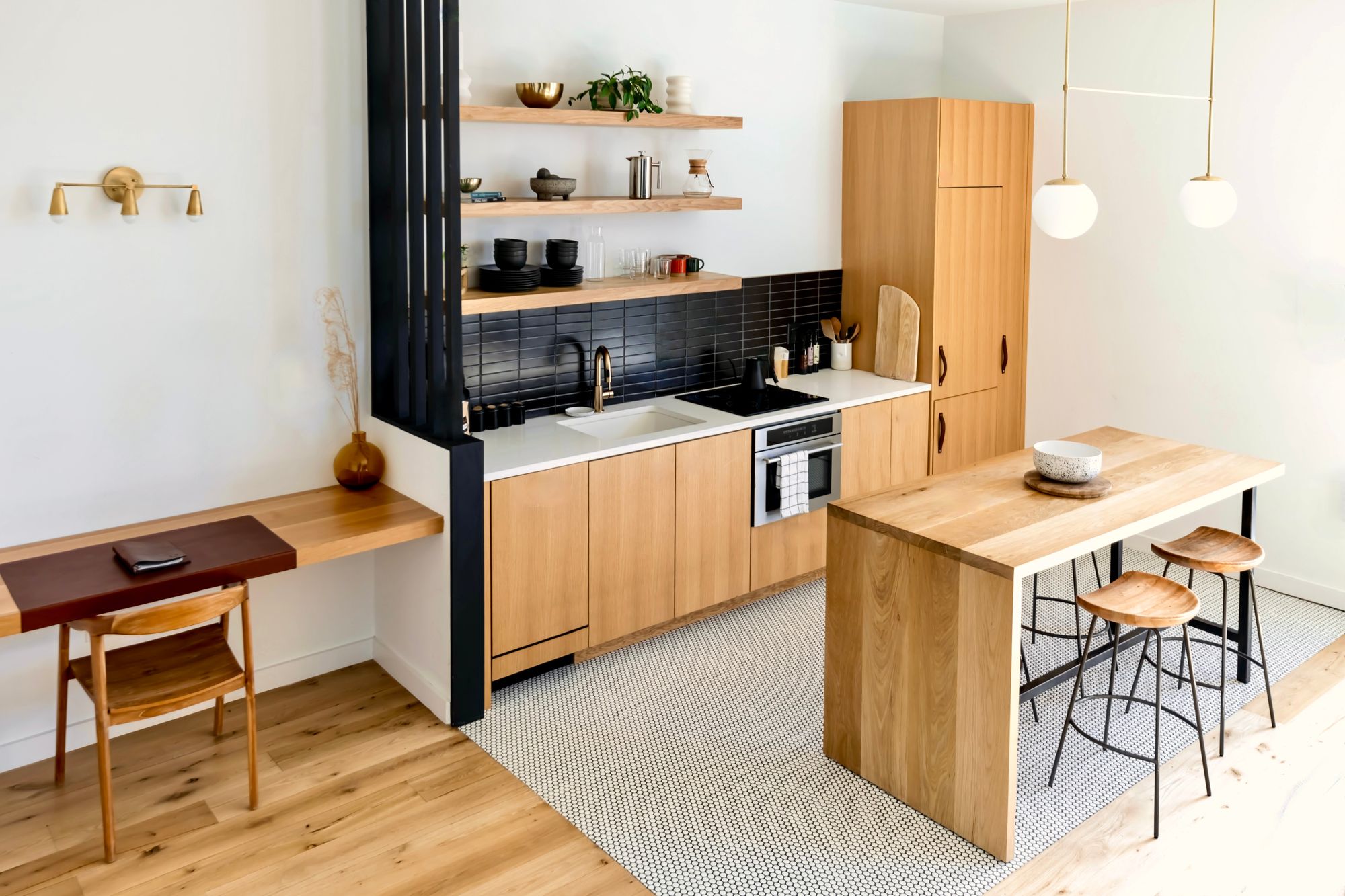 Kitchen with warm wooden cabinetry, an island and a white stone countertop